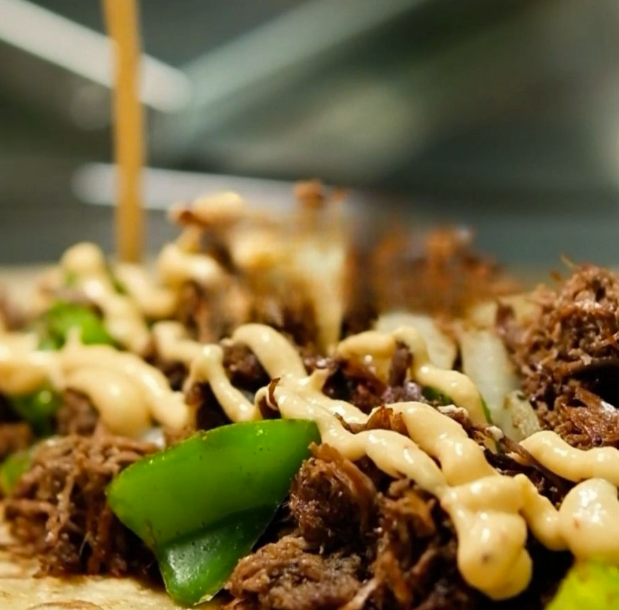Shredded beef, peppers, and sauce on a fresh paratha