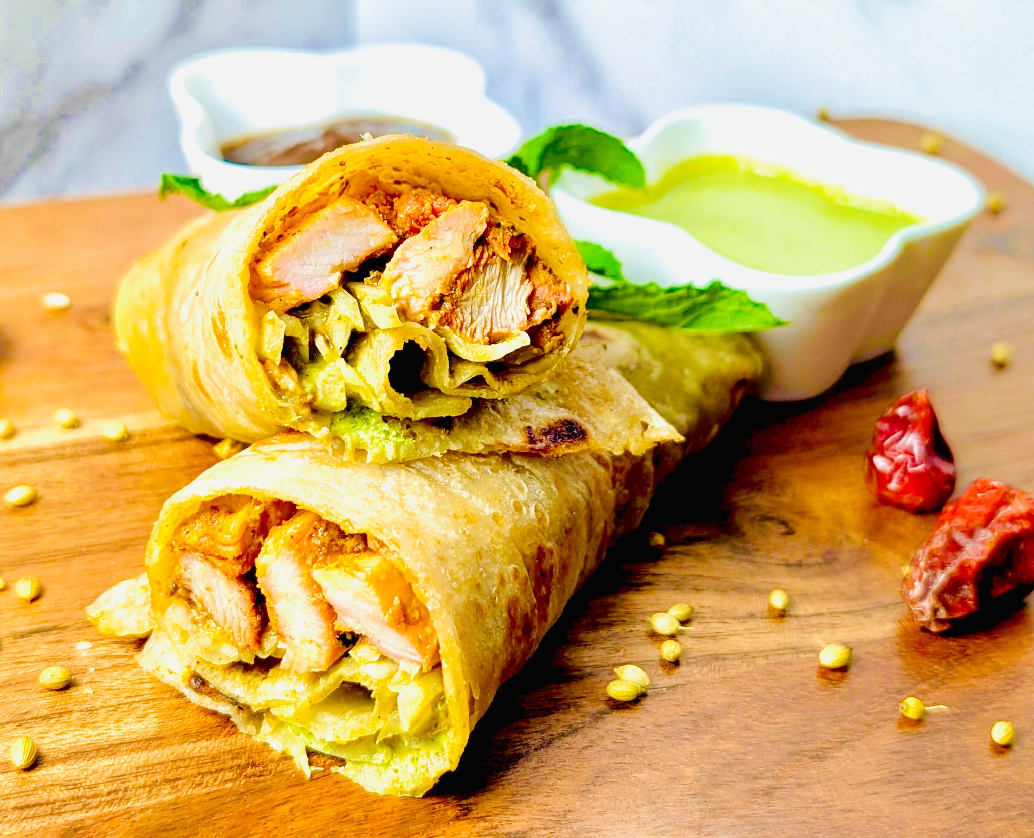 Chicken Tikka paratha rolls served with house chutneys