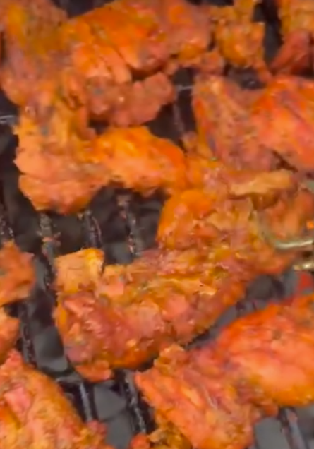 Spiced chicken cooking on the Rollup grill