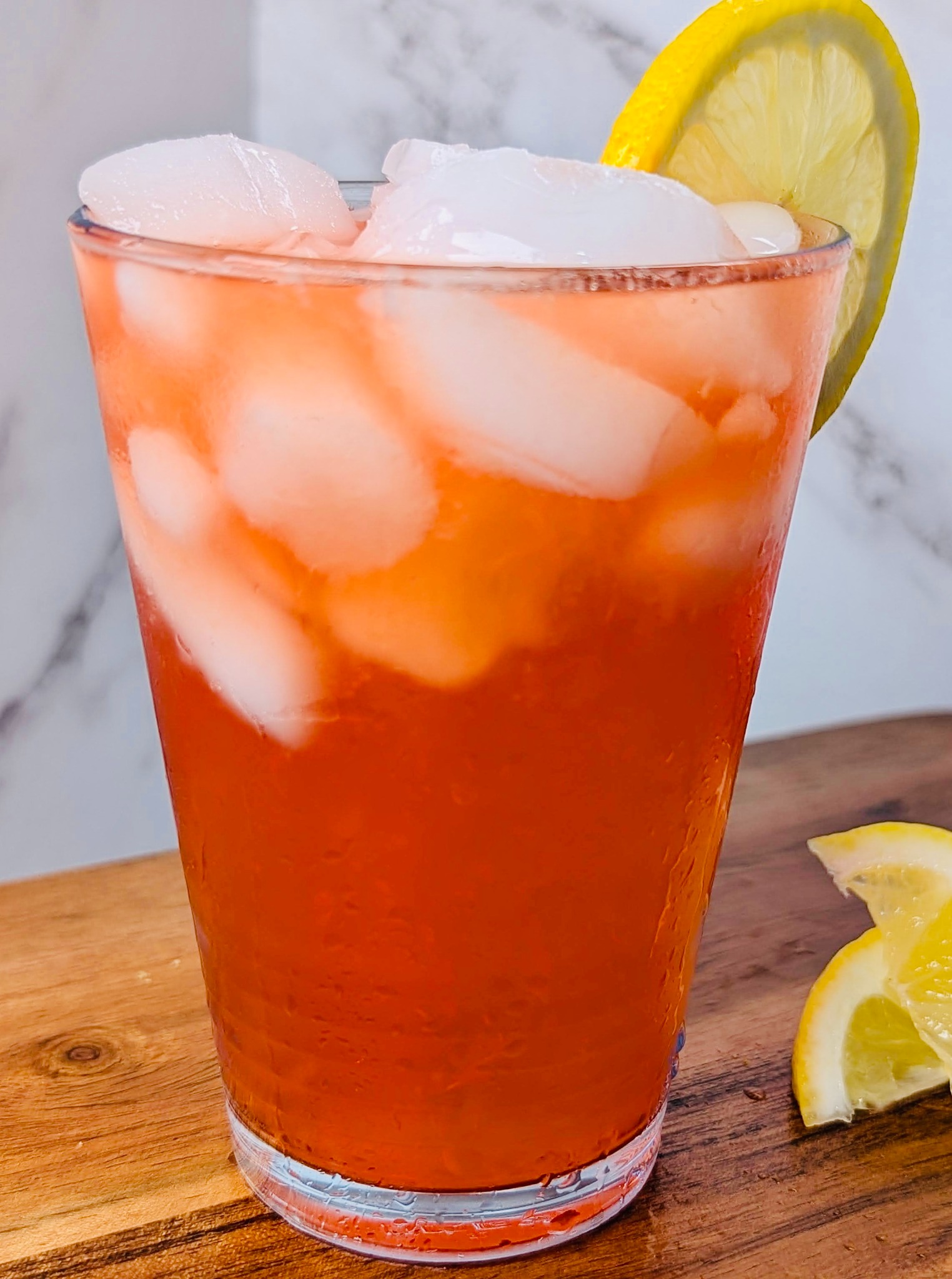 Iced house lemonade garnished with a fresh lemon slice