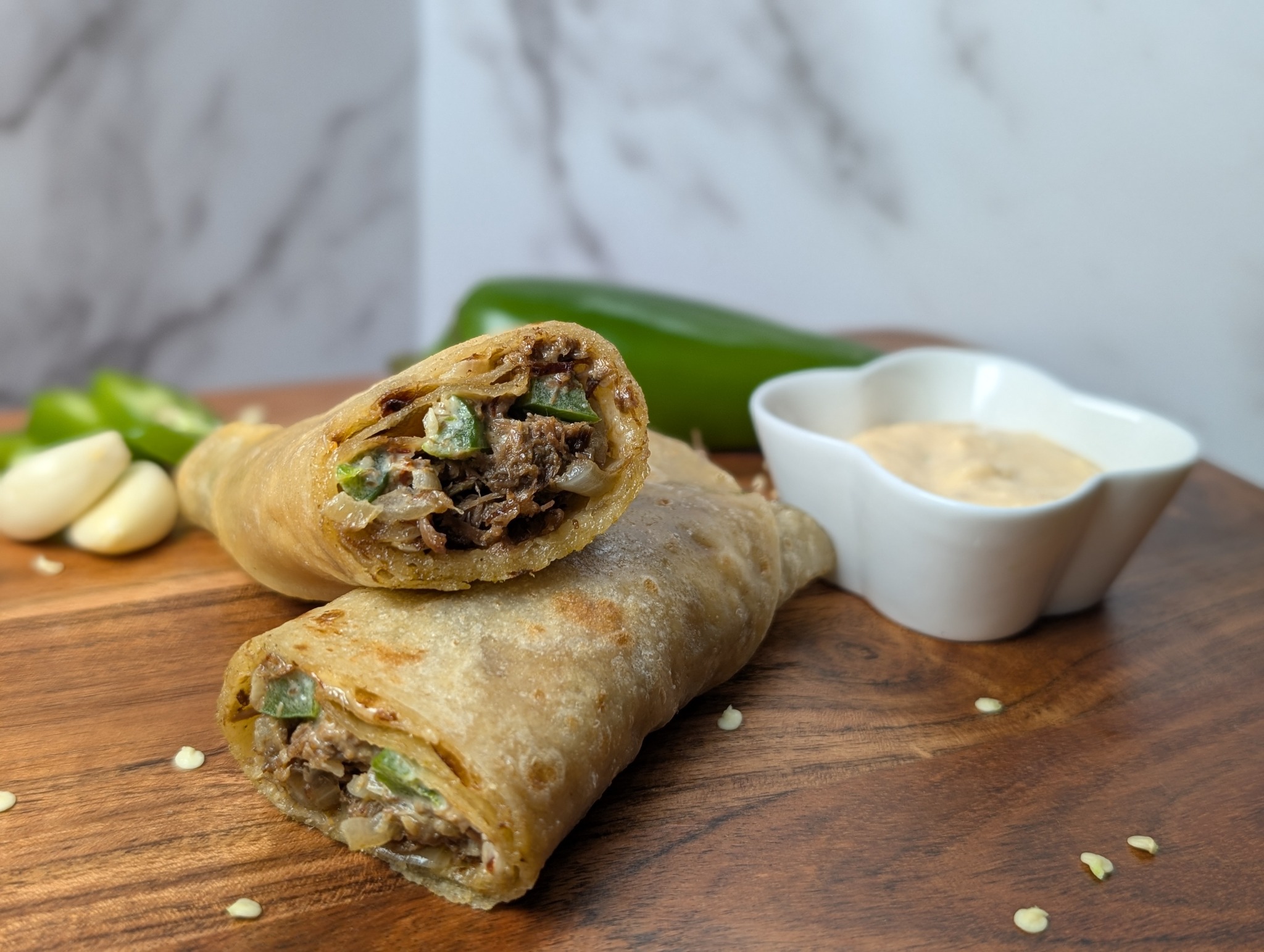 Hunter Beef paratha rolls with peppers, onions, and dipping sauce